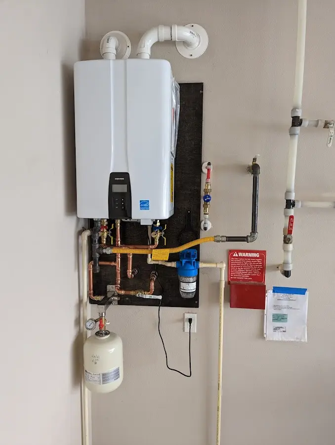 Professional plumber installing copper piping in a South Whitehall home